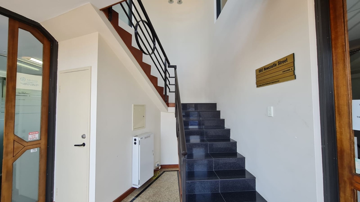 Office building entry and stair core, freshly painted in white